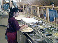 Applying toppings to the pizza